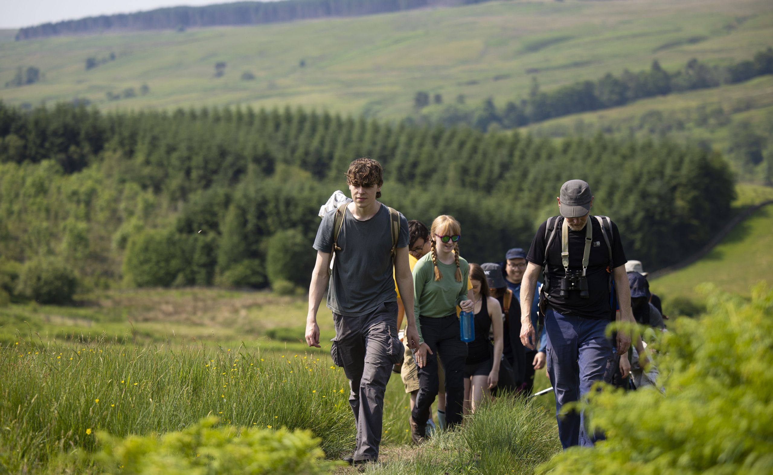 A group of people walking through the countryside